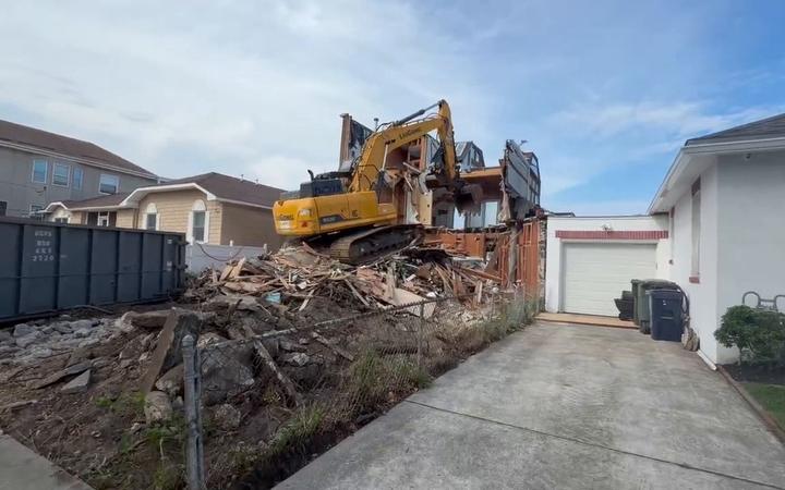 An excavator demolishing a two story home in Atlantic City