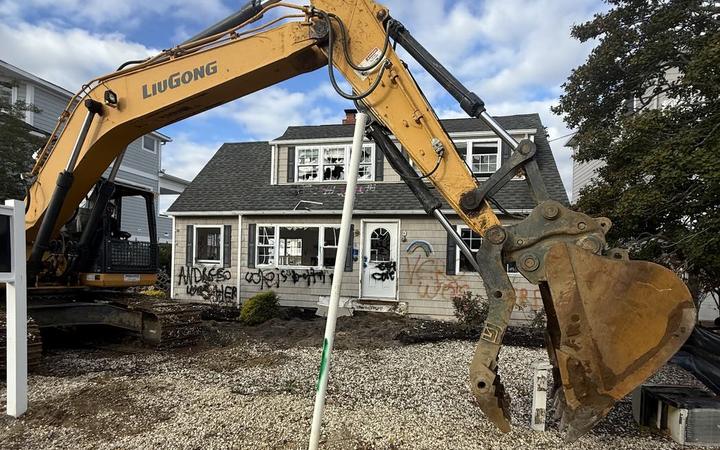 A vacant tagged house in Beach Haven West before demolition