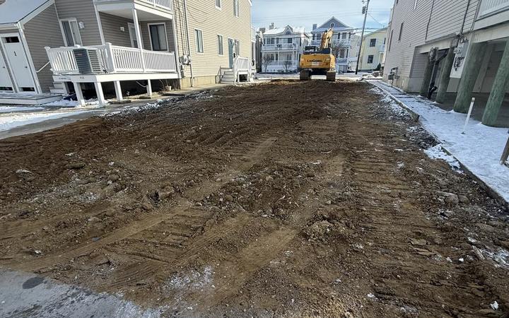 A cleared and graded lot between two Ocean City shore homes