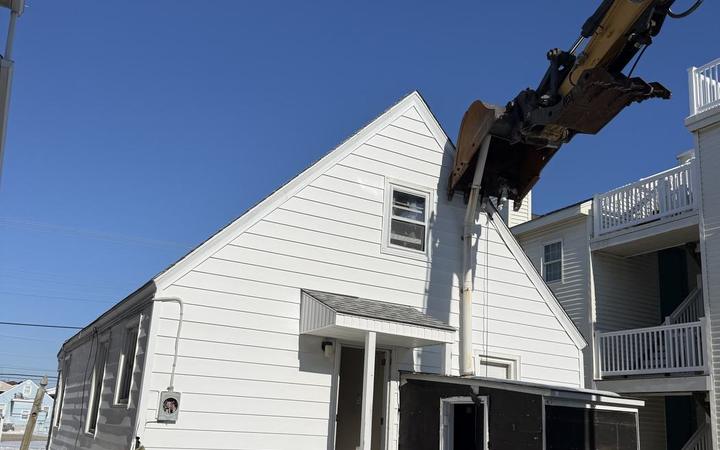 A white cape cod home in Ocean City before a winter teardown