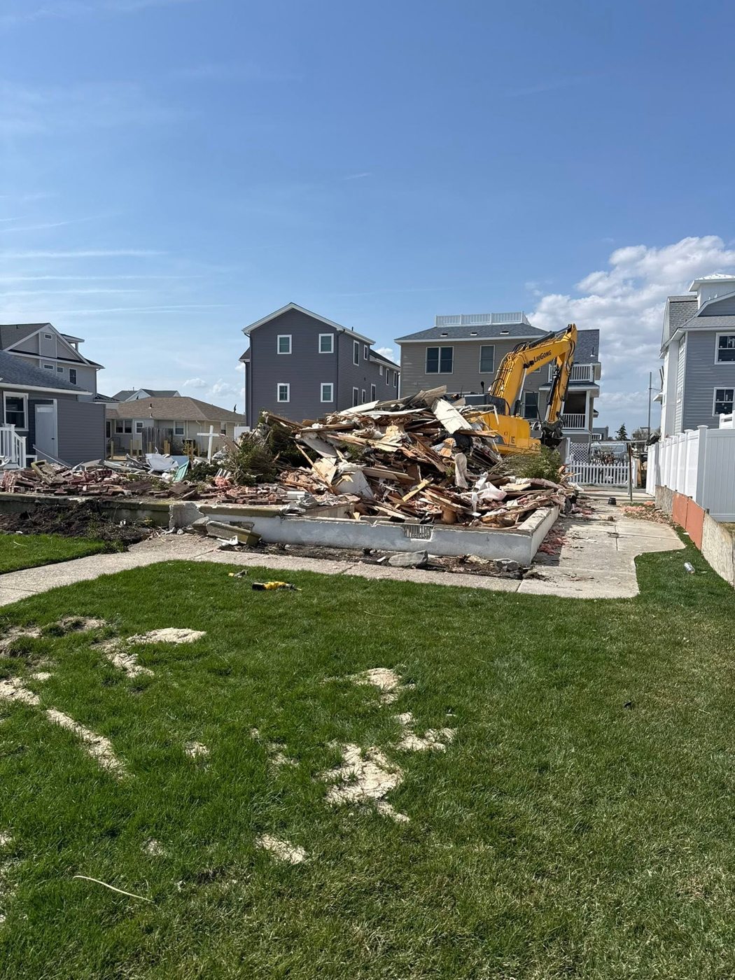 A cleared shore lot with the debris pile staged for hauling