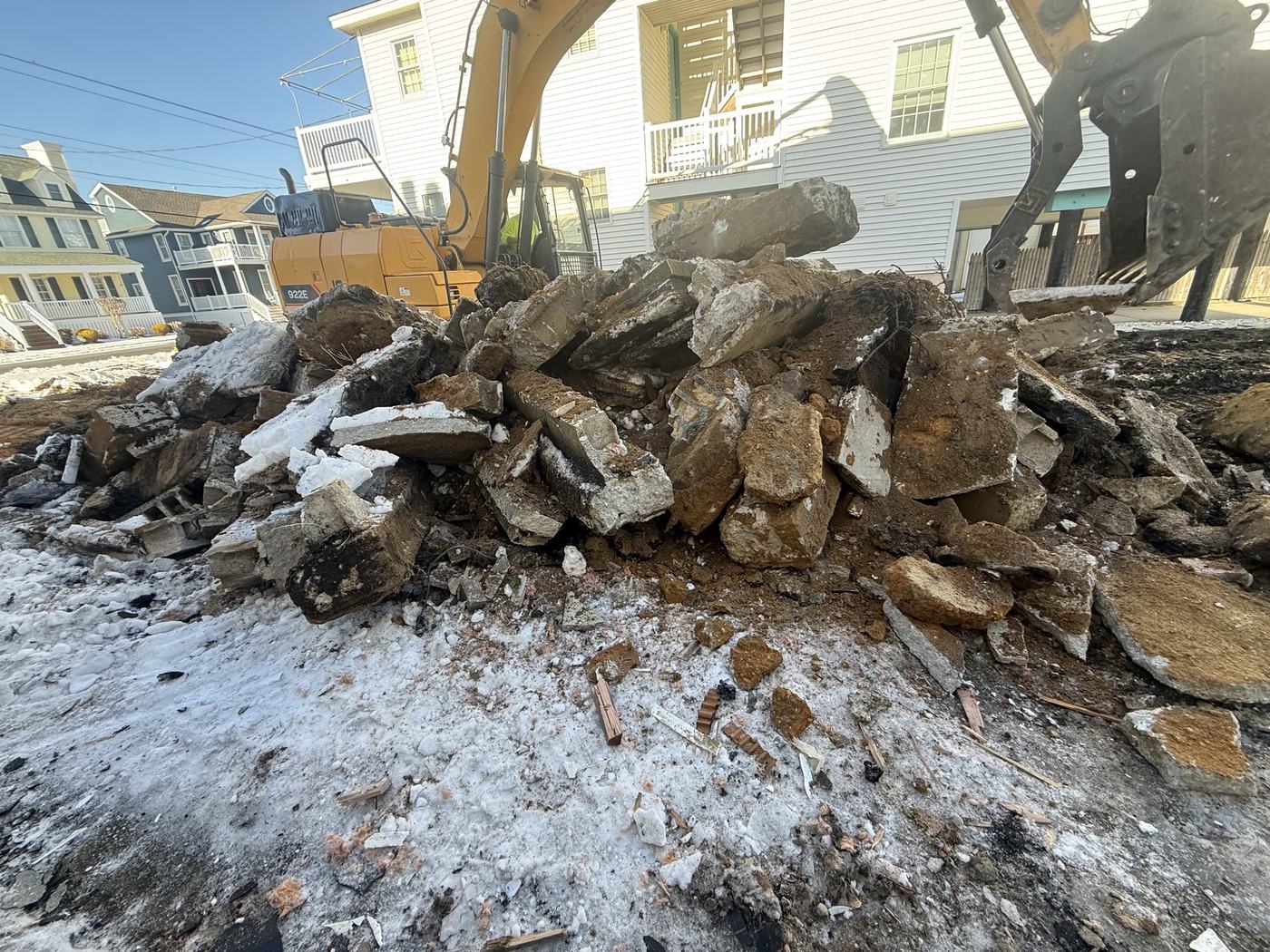 A pile of broken concrete and masonry staged for hauling off a demolition site